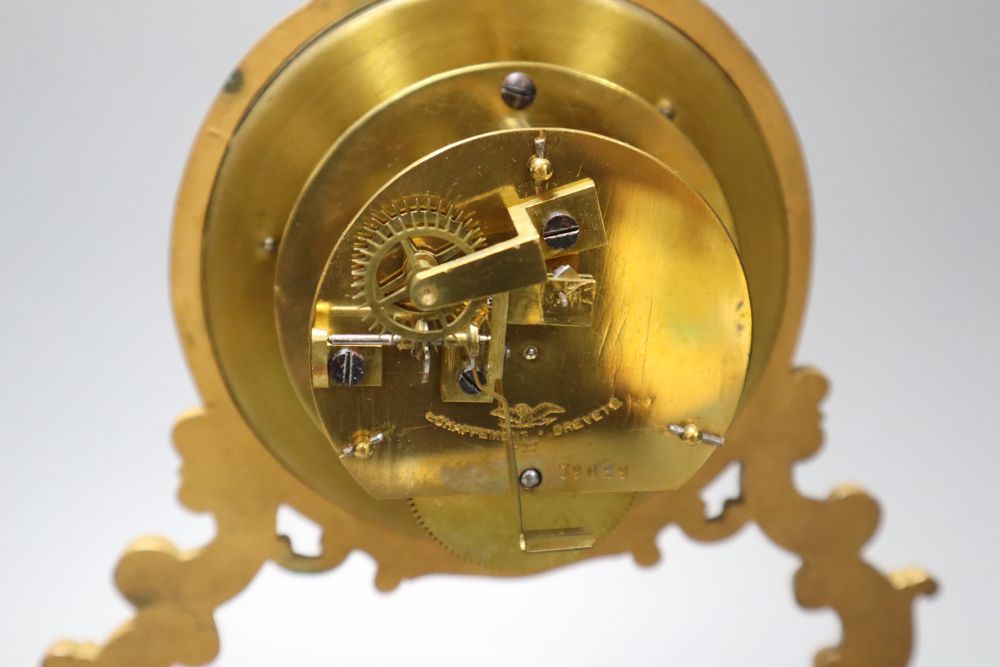 A 19th century French swinging cherub mantel timepiece under glass dome, French movement with exposed escapement, 35cm high